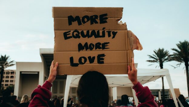Sign at a march saying 'more equality, more love'